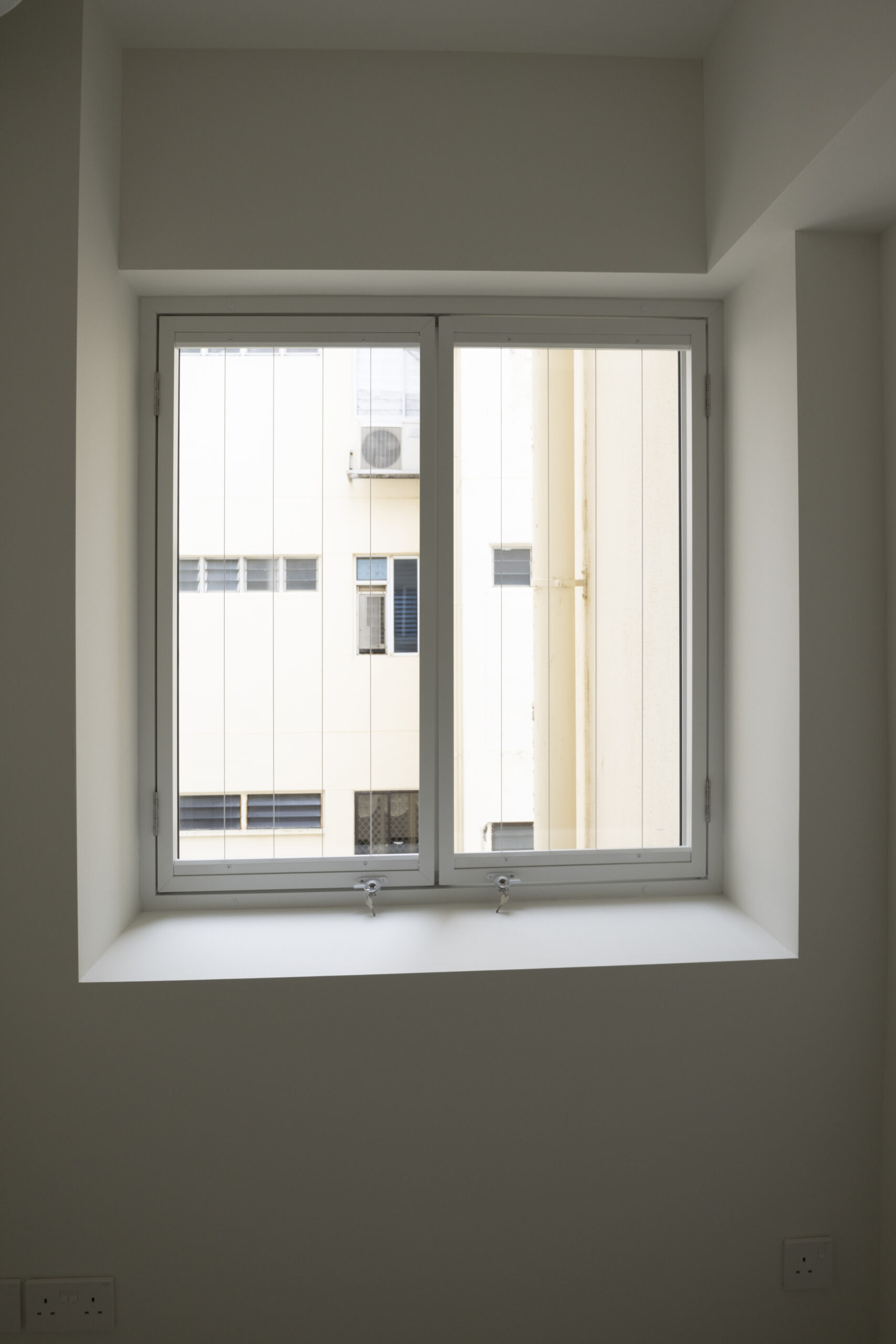 Aluminum window and door installation at Marine Vista with 4-track sliding door and white powder-coated finish