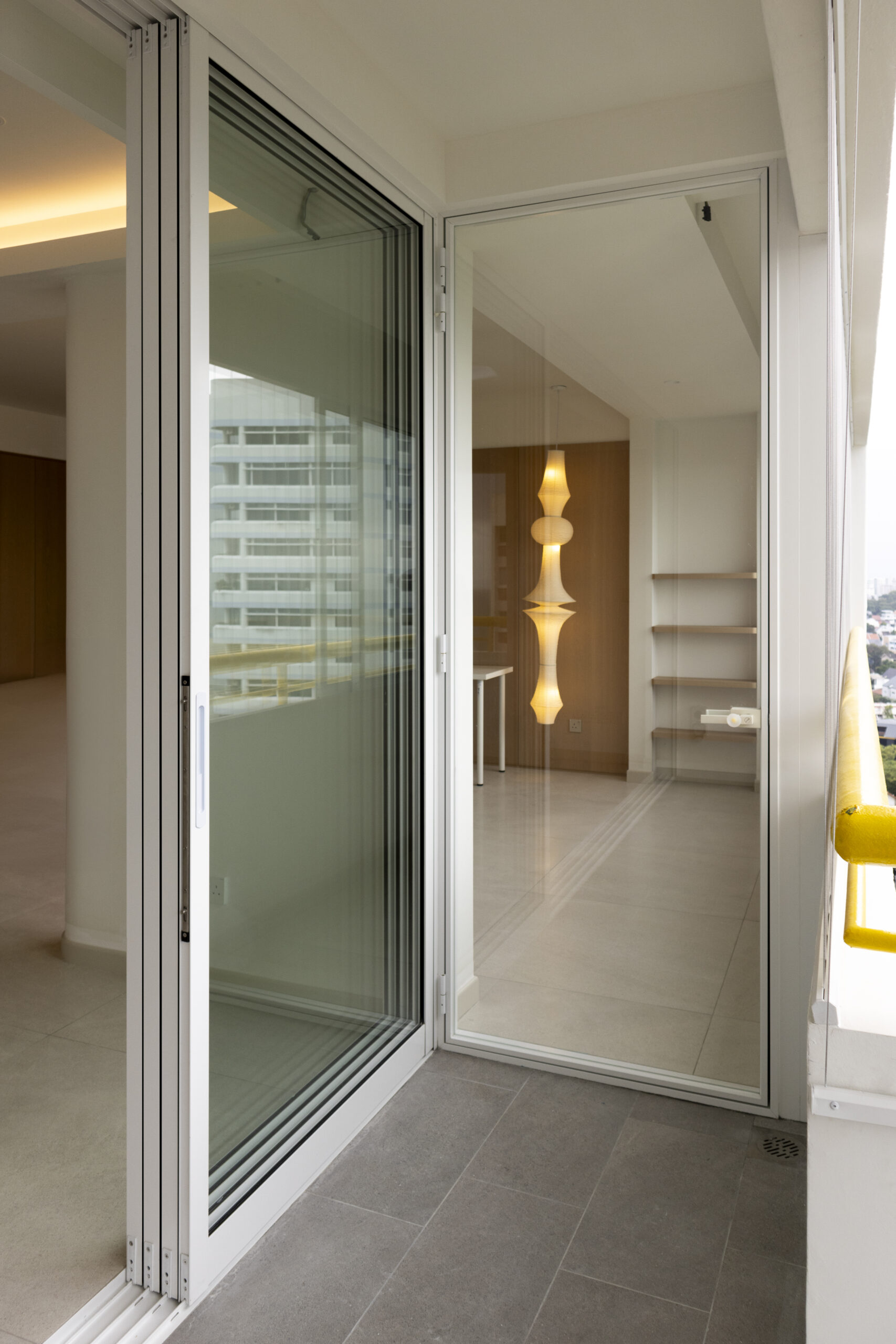 Aluminum window and door installation at Marine Vista with 4-track sliding door and white powder-coated finish