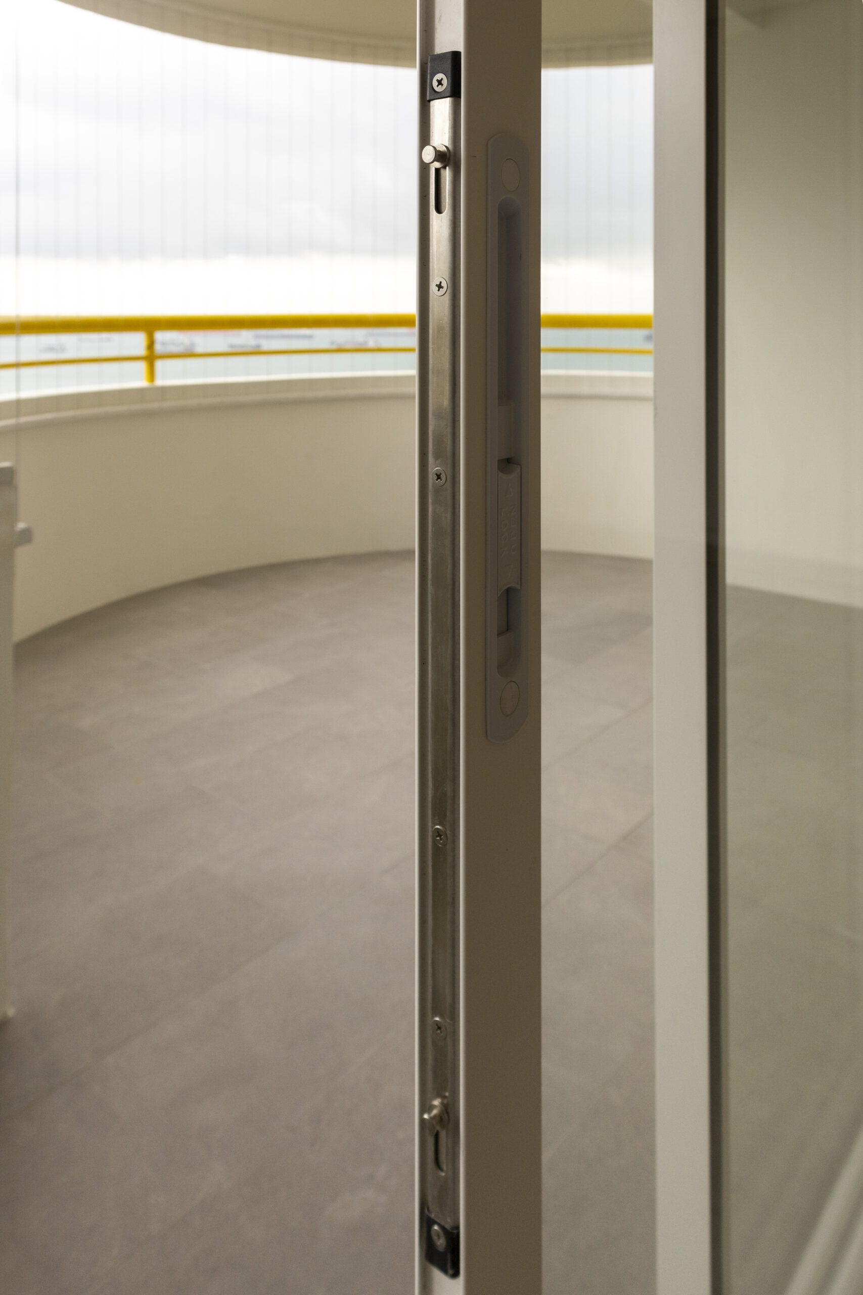 Aluminum window and door installation at Marine Vista with 4-track sliding door and white powder-coated finish