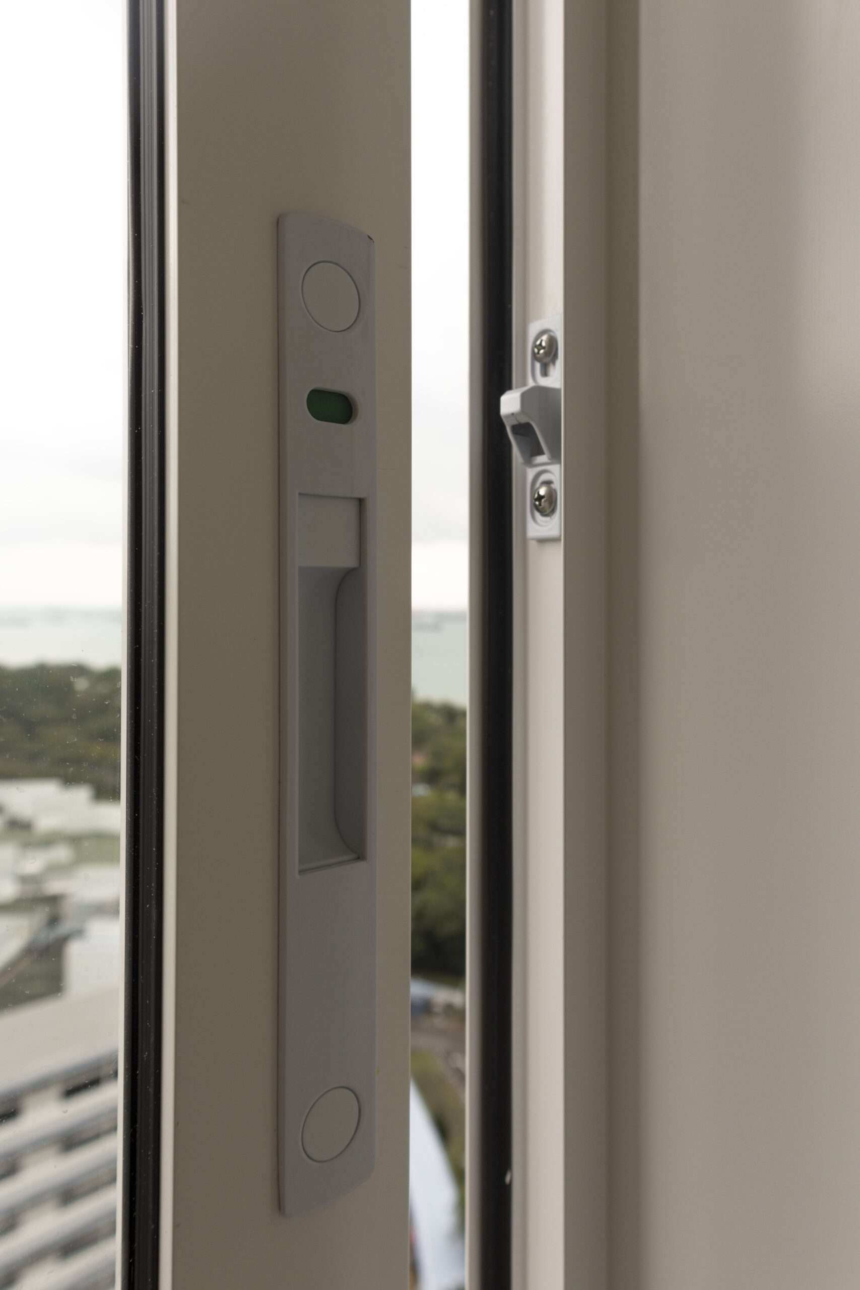 Aluminum window and door installation at Marine Vista with 4-track sliding door and white powder-coated finish