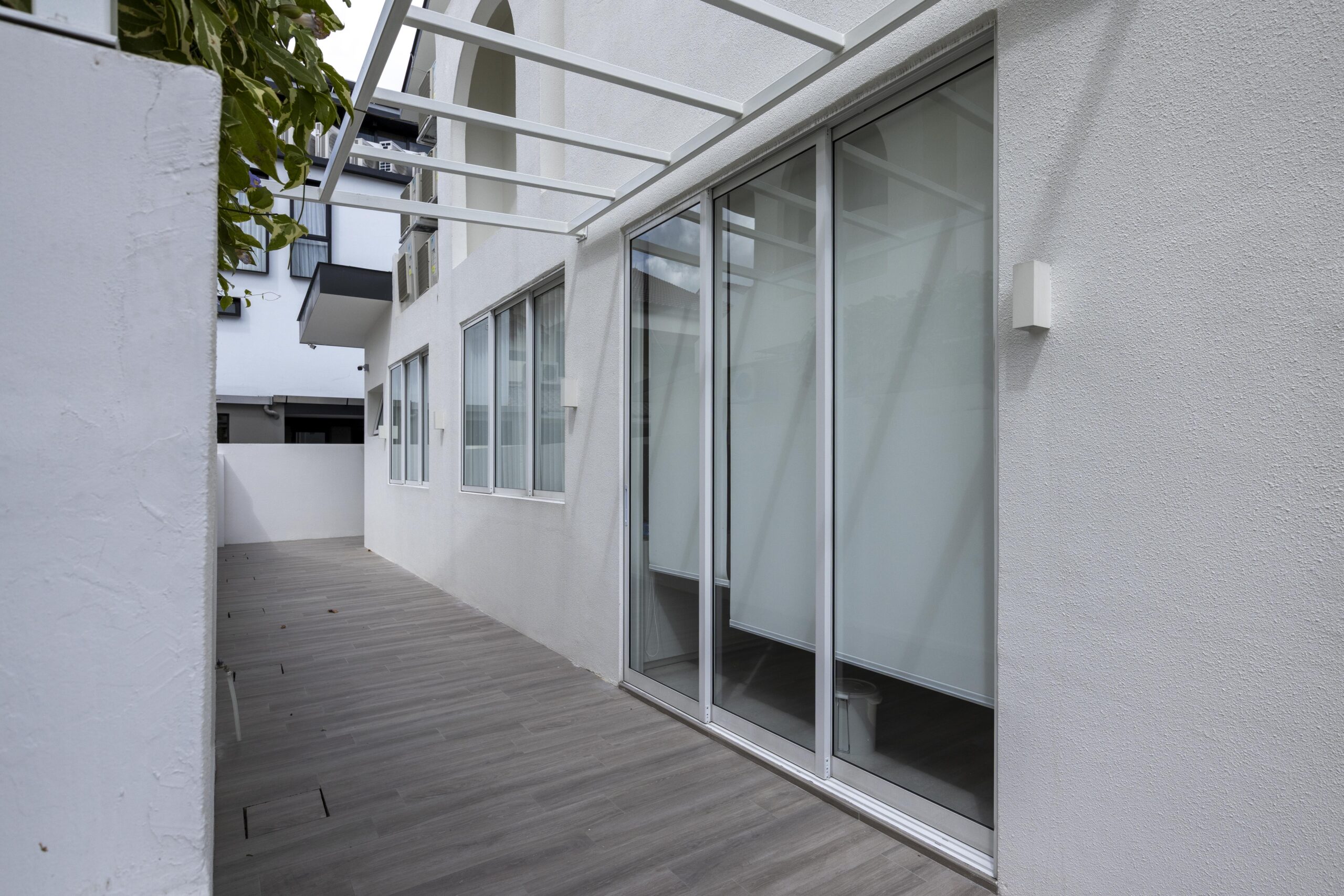 Full window and door system installation at Bedok Ria with sleek white frames and black accents
