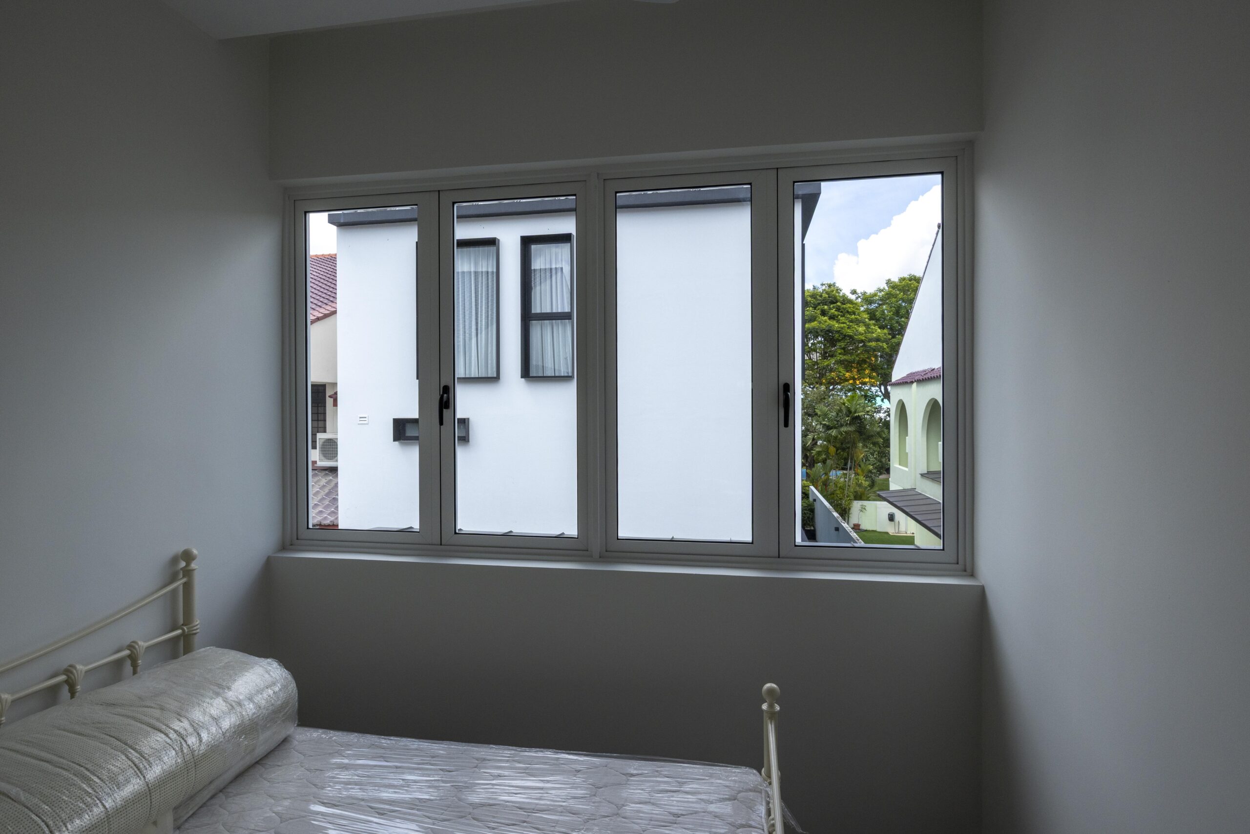 Bedok Ria window installation with white aluminium frames and black handles
