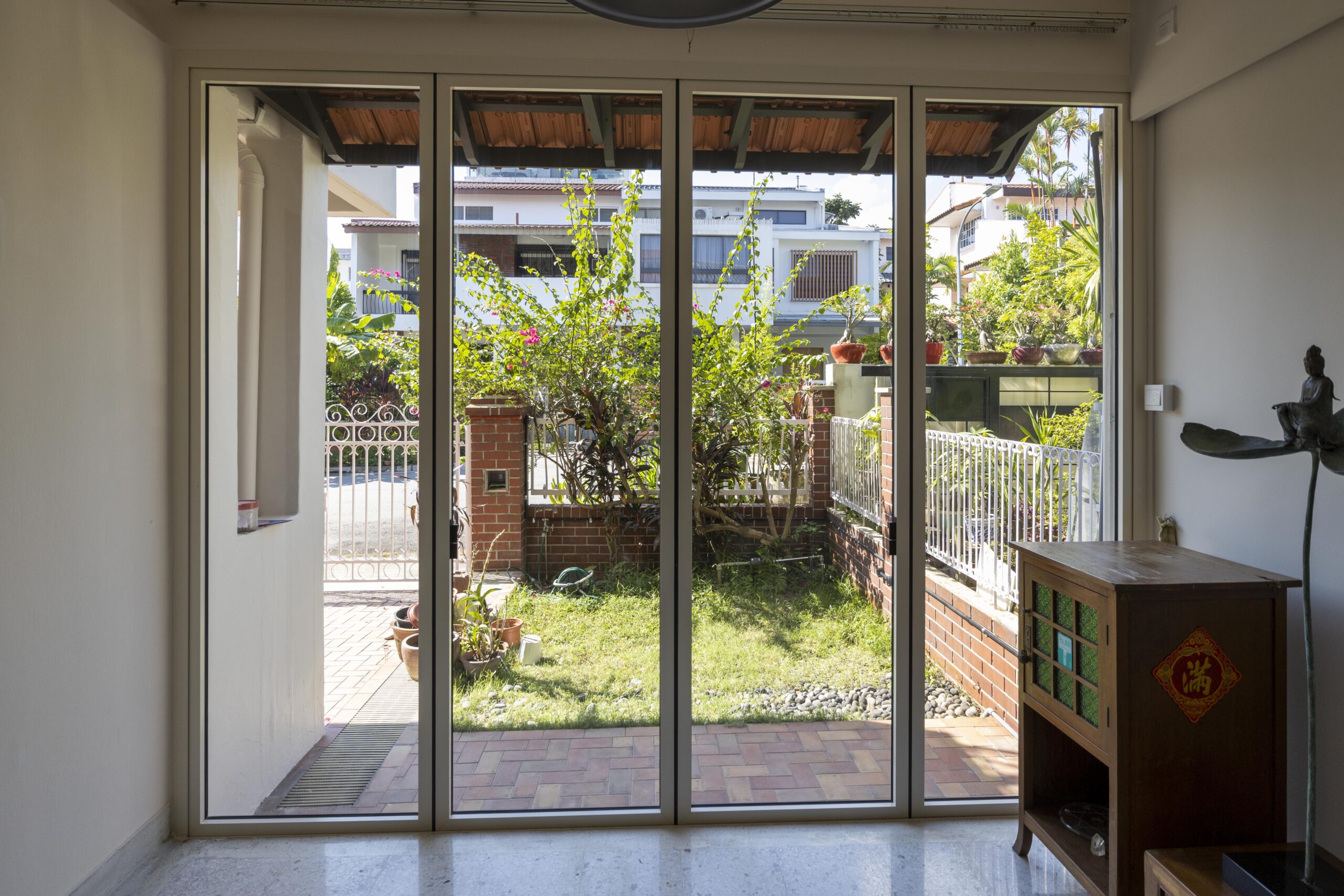 Slide and folding door system fully opened to both sides facing the garden.