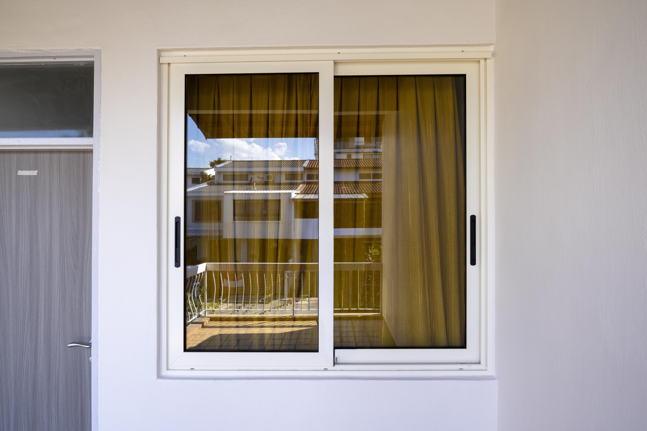 Euro profile sliding windows in 9210 Pale Beige for superior strength and insulation.