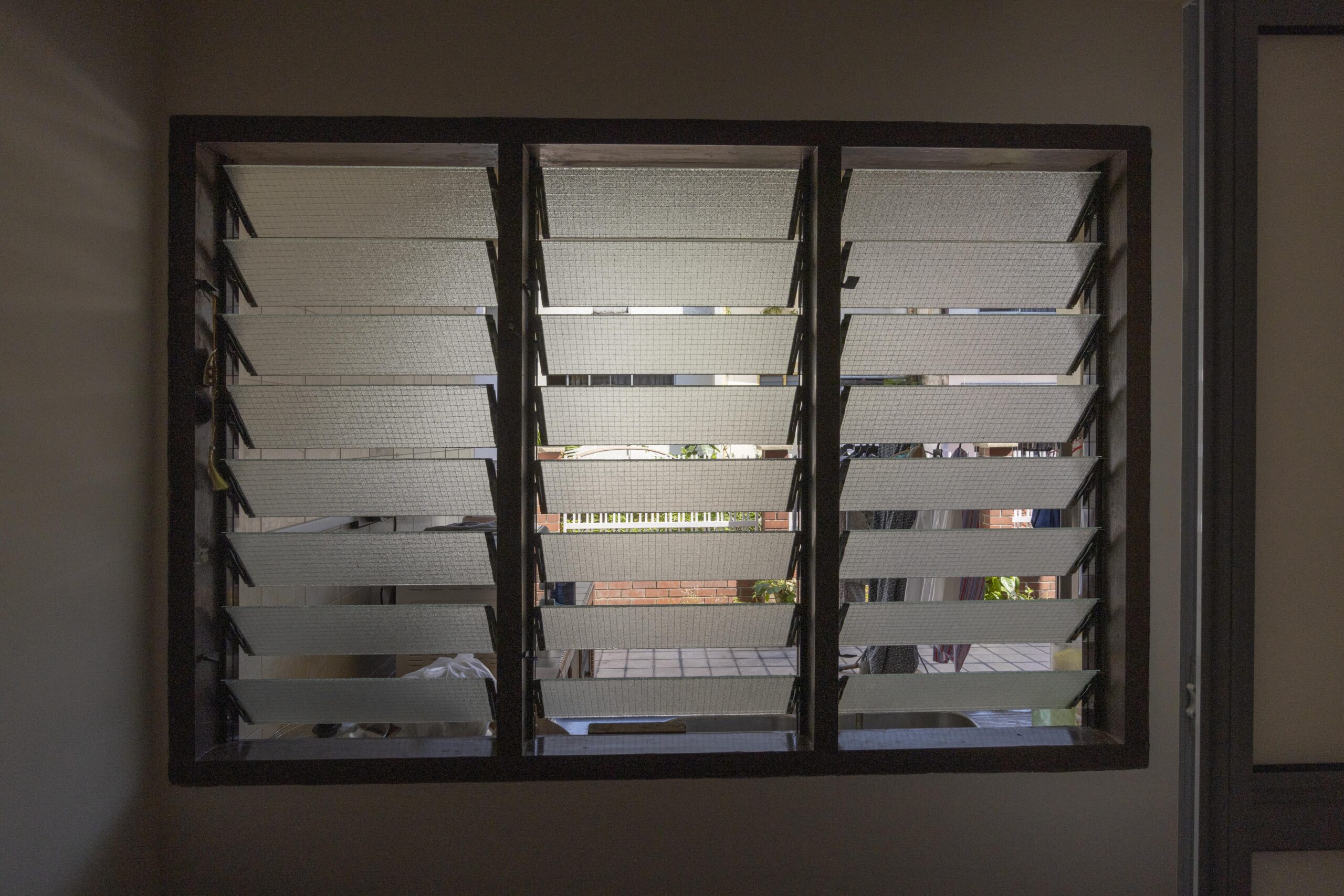 Adjustable glass louvres installed at the backyard area.