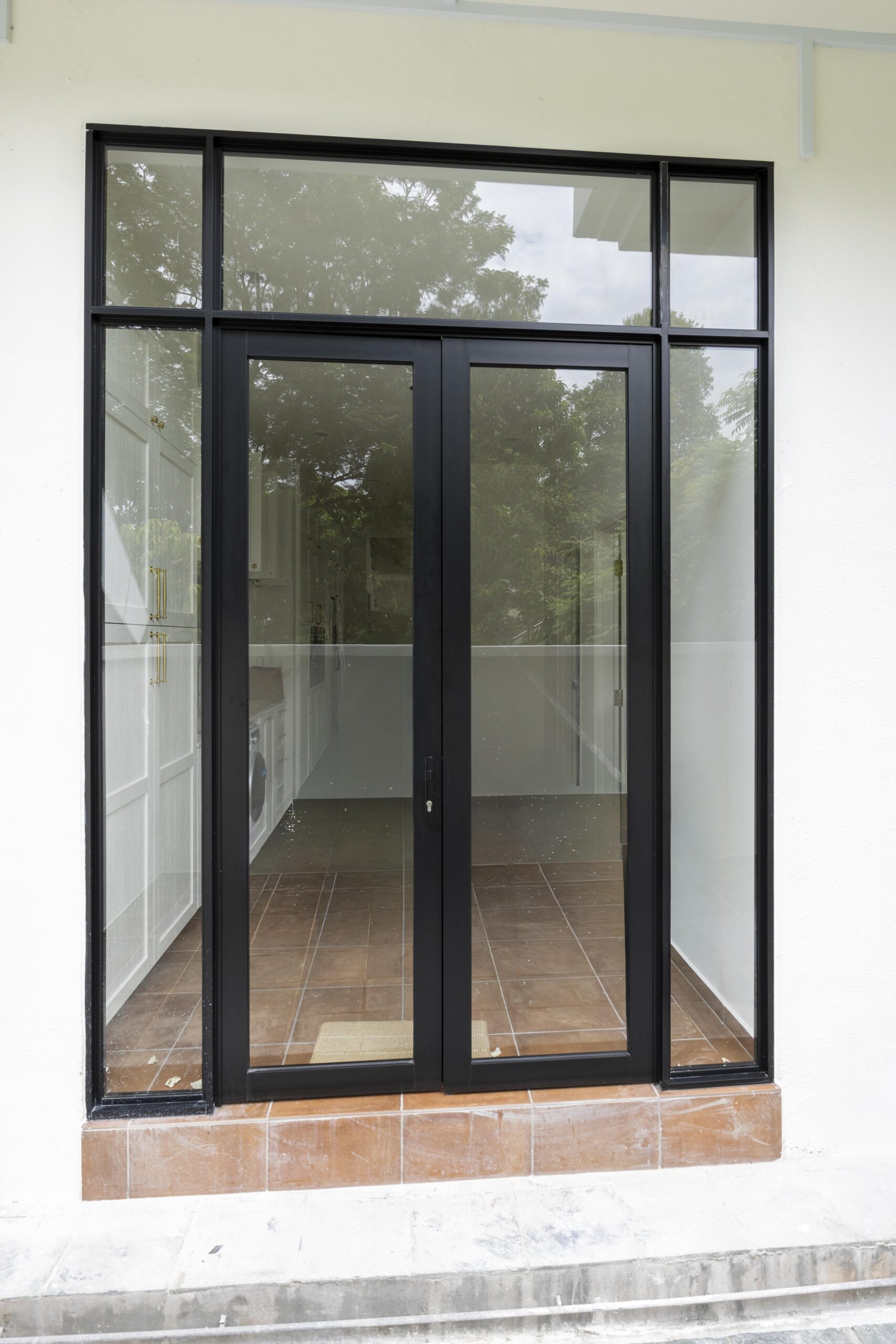 Black-framed backyard swing door providing bold design contrast