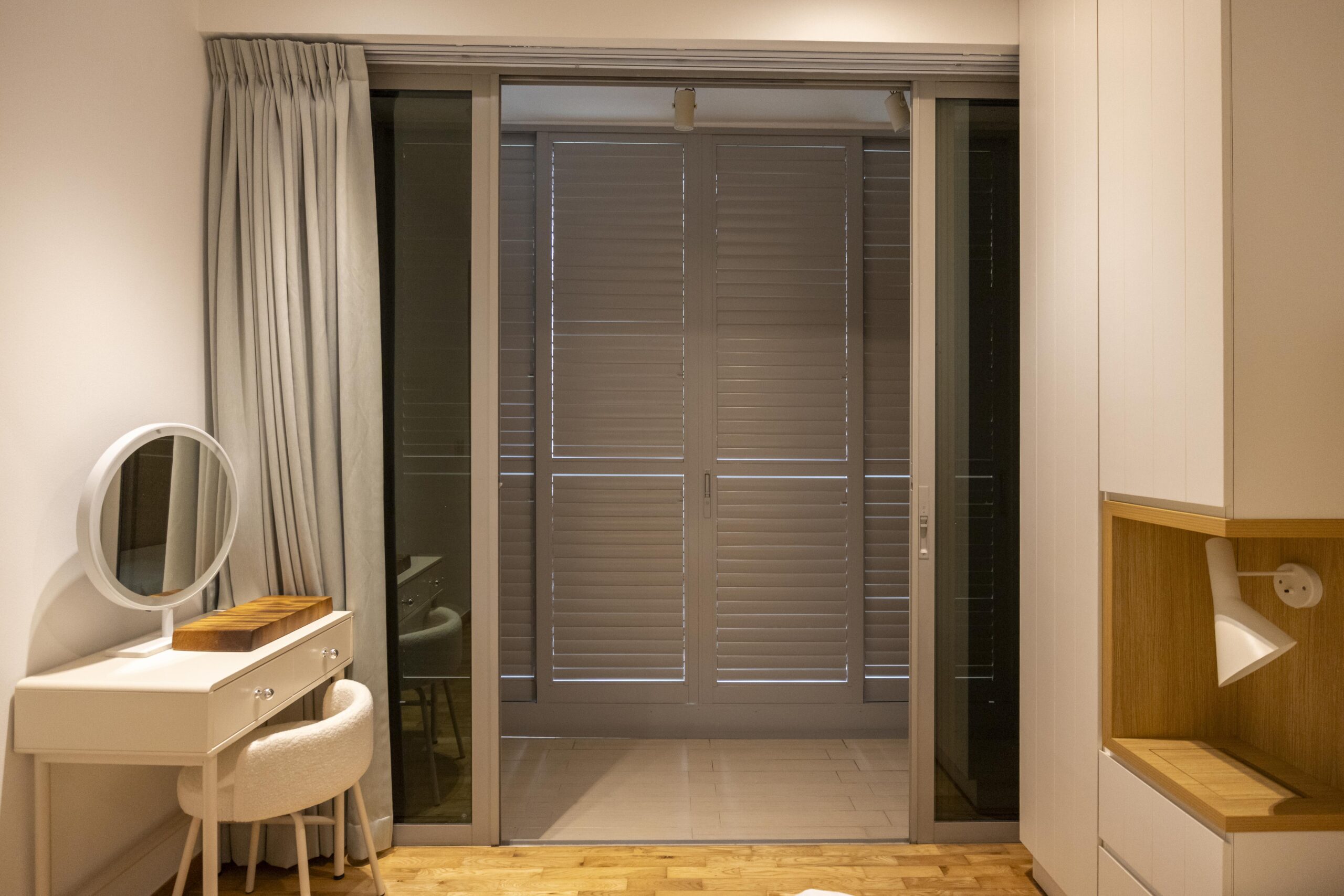 Sliding doors with powder coated adjustable aerofoil louvres installed along the balcony at Bartley Residence