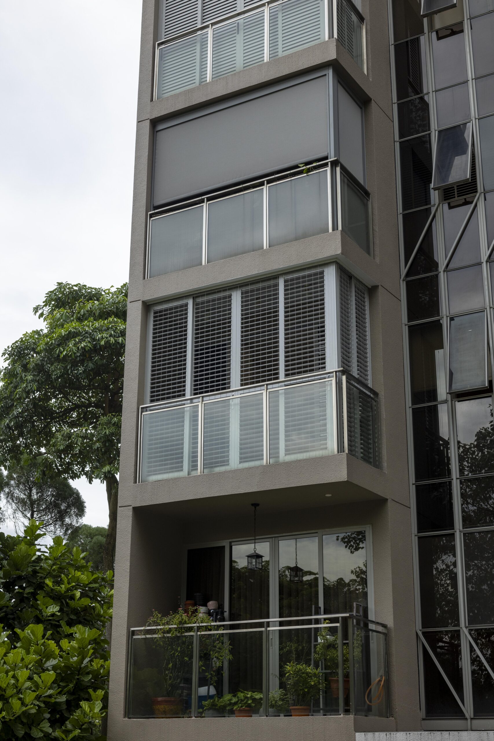 Sliding doors with powder coated adjustable aerofoil louvres installed along the balcony at Bartley Residence