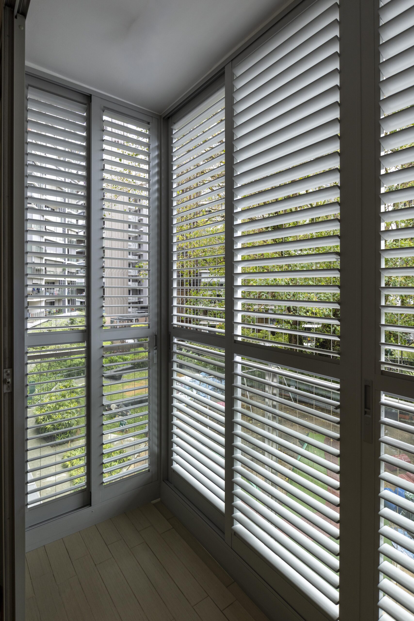 Sliding doors with powder coated adjustable aerofoil louvres installed along the balcony at Bartley Residence