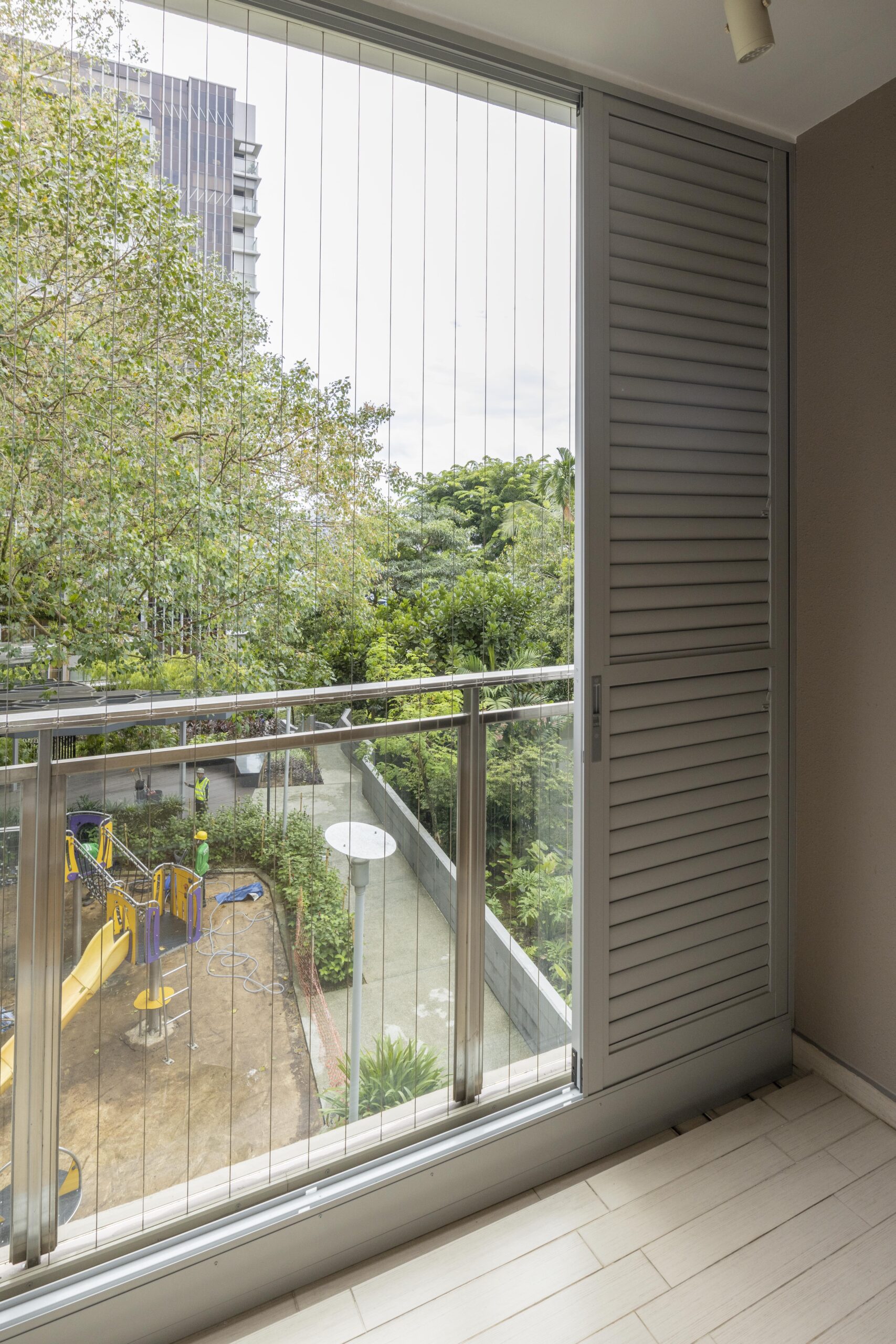 Sliding doors with powder coated adjustable aerofoil louvres installed along the balcony at Bartley Residence