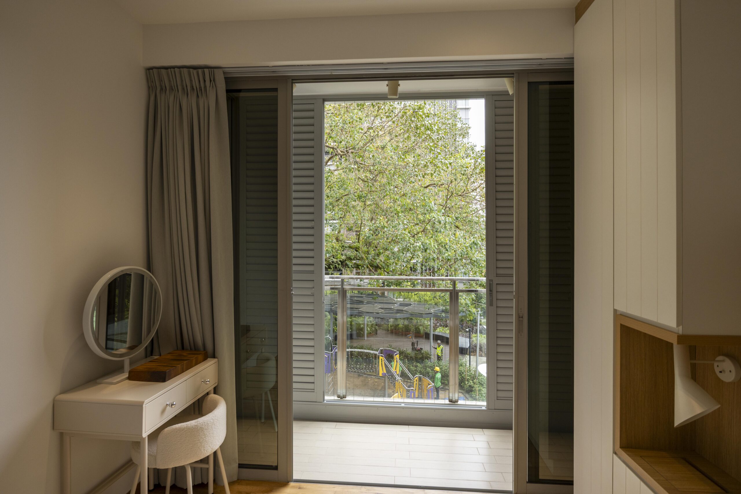 Sliding doors with powder coated adjustable aerofoil louvres installed along the balcony at Bartley Residence